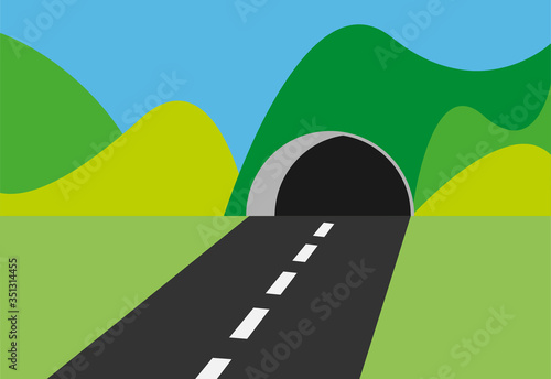 Carretera atravesando un túnel en un paisaje.