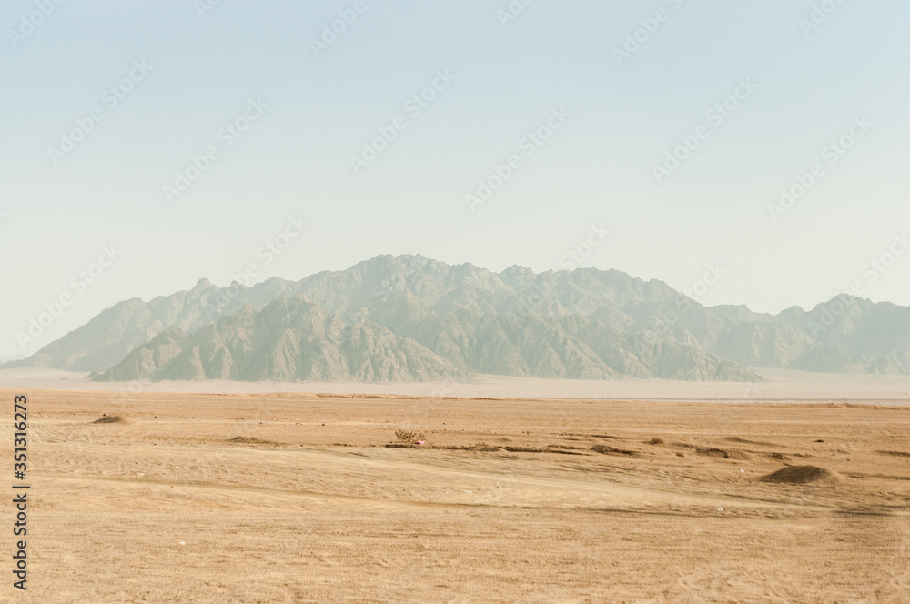 Fototapeta premium Riding a quad bike in the desert near the Sinai Mountains. Sharm El Sheikh. Photo on a sunny day..Holidays in 2018.