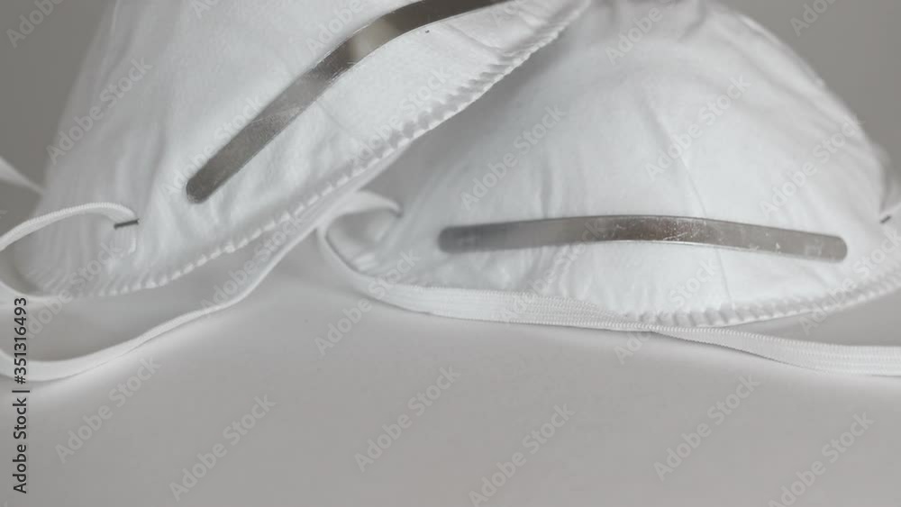 Closeup of white face masks on a white table, slow zoom Closeup of white face masks on a white table, slow zoom