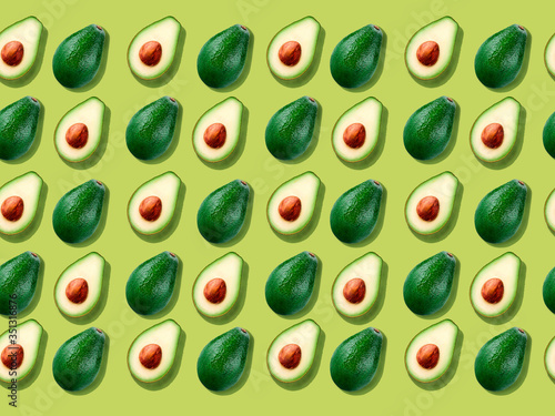 Seamless background with avocado on yellow.