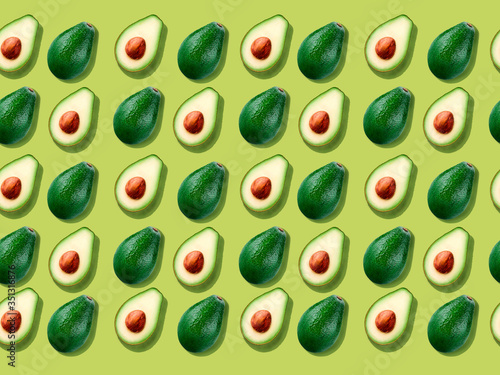 Seamless background with avocado on yellow.