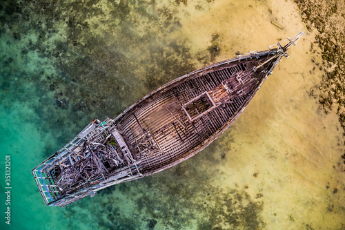 Aerial view of the abandoned old shipwreck at the coast of the Celebes Sea, Maratua Bohesilian near Borneo, Indonesia. photo