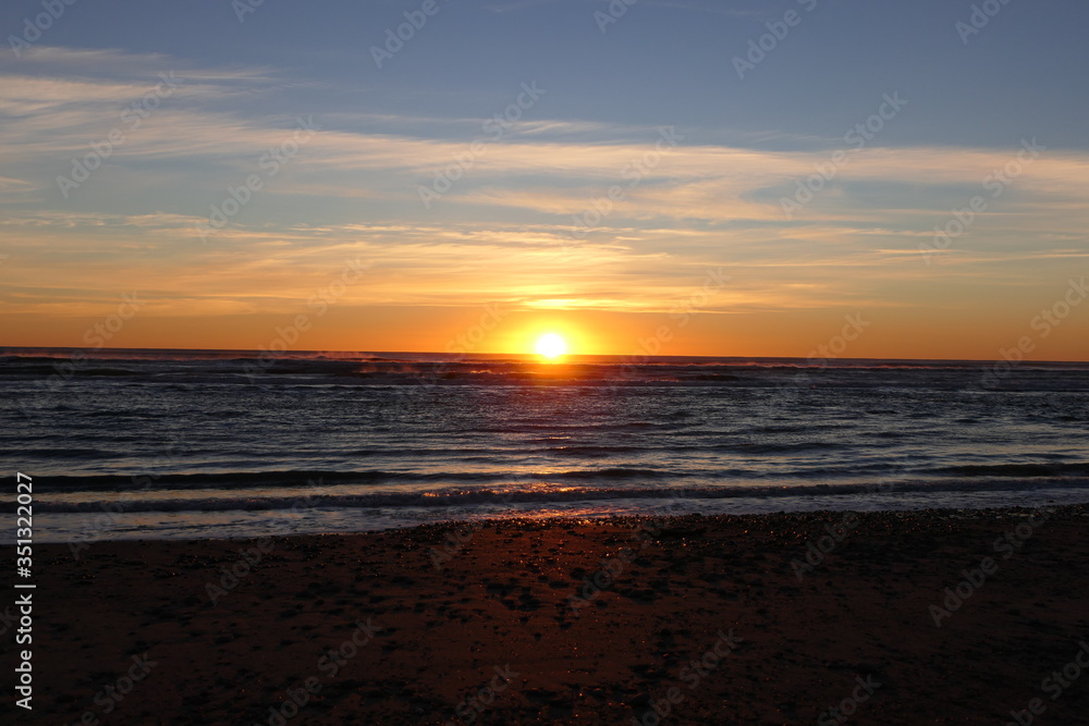 Sun sinks at the horizon of the Tasman Sea, observed from New Zealand's west coast