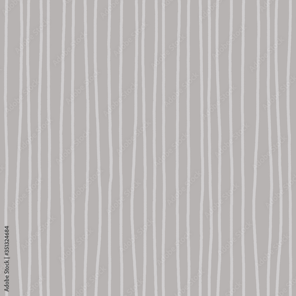 Obraz premium Light gray freehand wavy uneven irregular vertical lines on a darker background. Abstract striped seamless pattern for textile, wrapping paper, background textures.