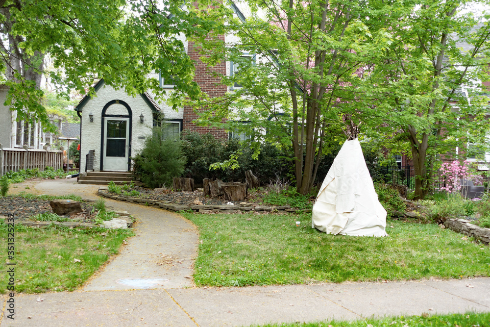 Home with a teepee style tent in the front yard. St Paul Minnesota MN USA