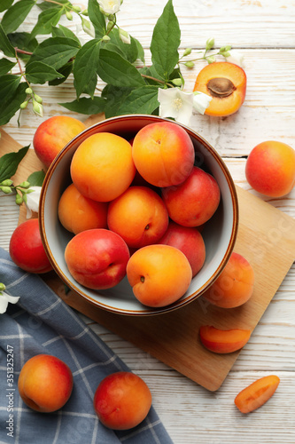 Composition with tasty apricots on white wooden background, top view