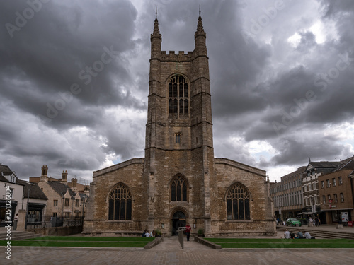 The old church in the middle of the city and dramatic sky in the background