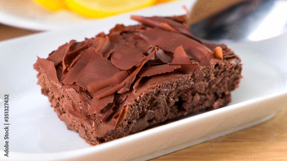 Chocolate tasty cake with spoon on table, close-up Chocolate tasty cake with spoon on table, close-up