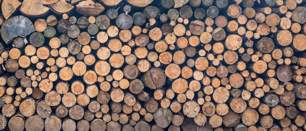 stacked firewood - texture background of wood logs stacked firewood - texture background of wood logs