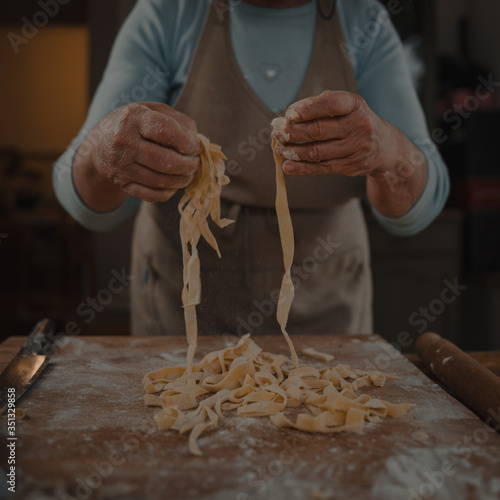 grandmother prepares homemade noodles