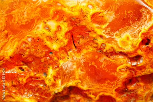 Modern luxury background. Sun stone texture. Patterns of different colors in amber macro photography. Ancient fossil resin. Inclusions in amber. Sun stone. Beautiful natural patterns. Copal