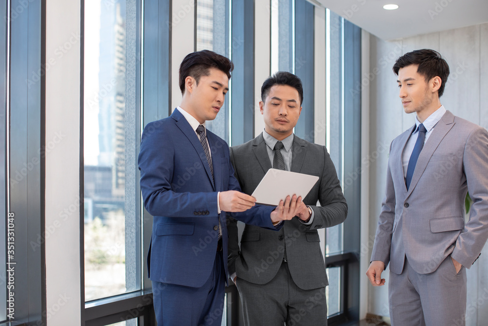 Successful businessmen talking in office Successful businessmen talking in office