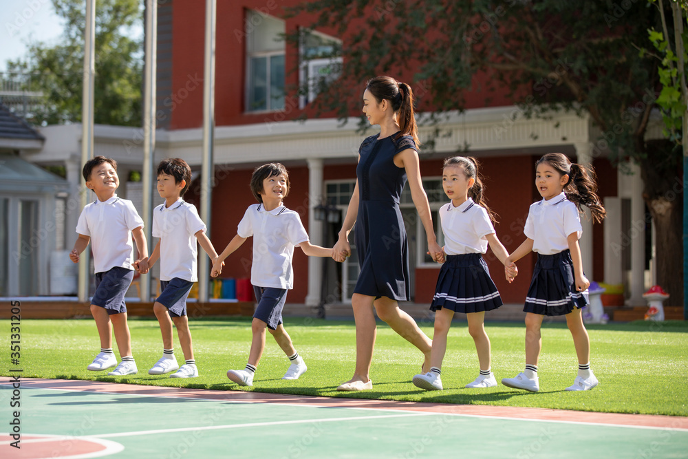 Teacher and students in kindergarten playground Teacher and students in kindergarten playground