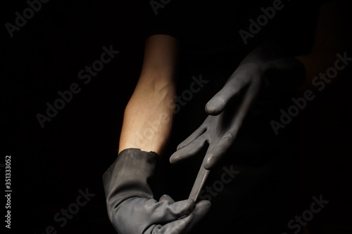 Hand gestures industrial black rubber gloves for personal safety hand wearing the personal protective equipment - ppe hygiene
