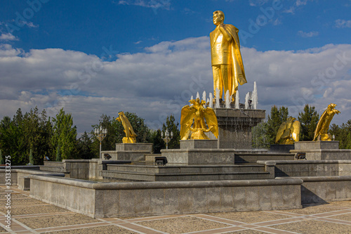 ASHGABAT, TURKMENISTAN - APRIL 17, 2018: Saparmurat Niyazov golden statue in Ashgabat, Turkmenistan photo