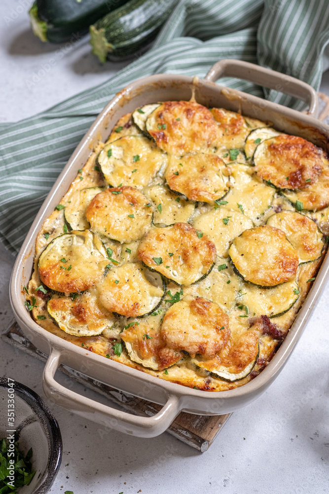 casserole with cheese and zucchini in baking dish casserole with cheese and zucchini in baking dish