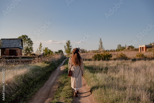 Young woman walking in the countryside. 