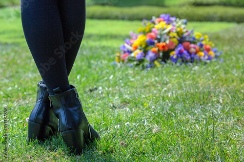 crossed feet facing funeral wreath