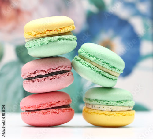 Fototapeta Naklejka Na Ścianę i Meble -  Close up of macaron desserts in front of a colorful spring vibe background
