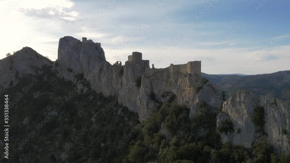 Chateau De Peyrepertuse on top of dramatic rock face, aerial perspective Chateau De Peyrepertuse on top of dramatic rock face, aerial perspective