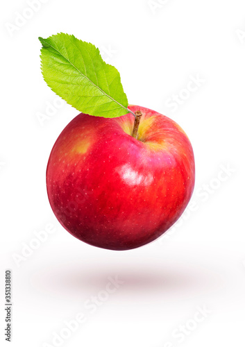 Red apple with green leaves fly on a white background.