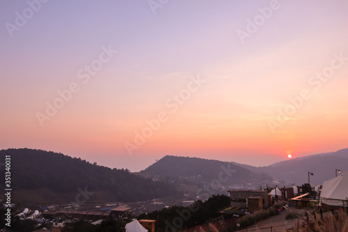 Colorful sunset over the mountain hills in a thai village near mountains in Chiang Mai, Thailand. The mountain scenery view