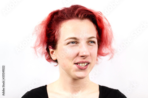 Close-up of a sad girl looking dreamily into the distance with her fingertips on her chin . On white background. Emotion of dreams. Bad hair day photo