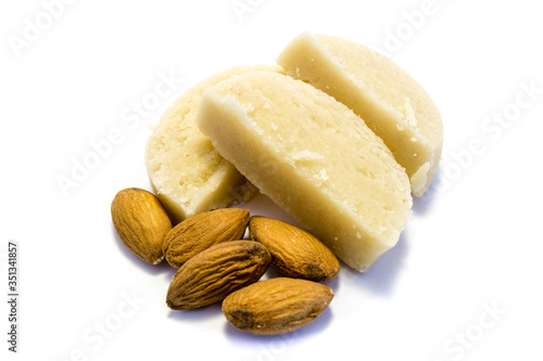 Piece of marzipan with almonds isolated on white background photo
