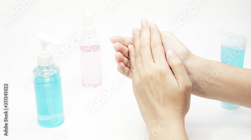Woman cleaning hands with alcohol gel.Women using bottle of antibacterial sanitiser soap.