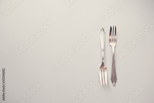 Old cutlery, lying on a wooden table. Texture, background