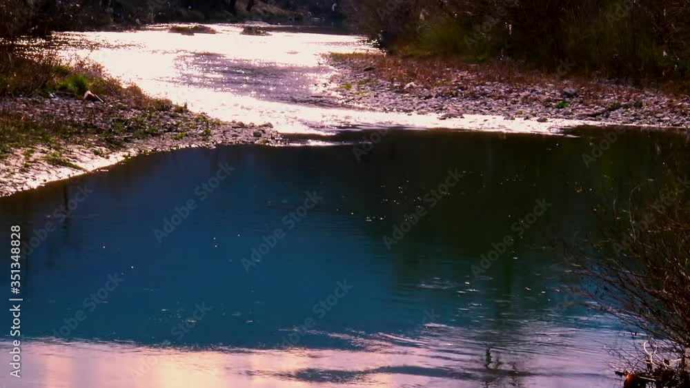 Calm river flowing at sunset of sunny spring time day. Calm river flowing at sunset of sunny spring time day.