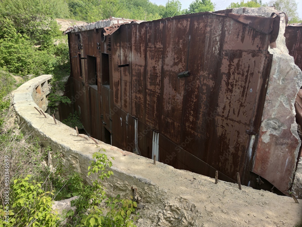 Wall of the old Soviet bunker. Bomb shelter. Rusty metal, gray concrete slab Wall of the old Soviet bunker. Bomb shelter. Rusty metal, gray concrete slab
