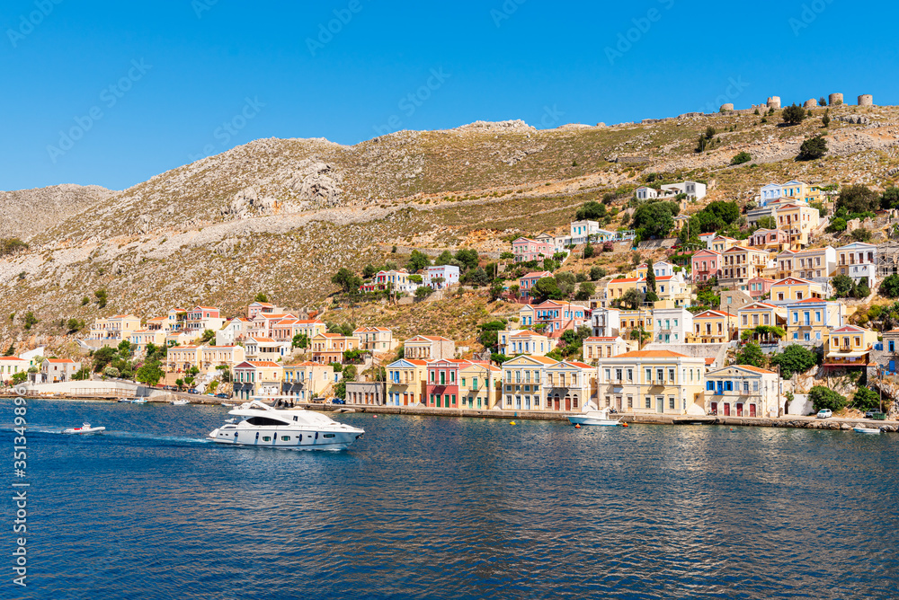 Sea bay and colorful houses on the hillside of the island of Symi. Greece