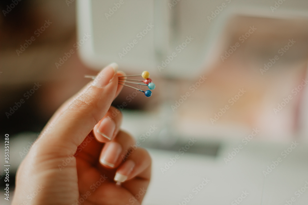 close up of a hand holding a needle close up of a hand holding a needle