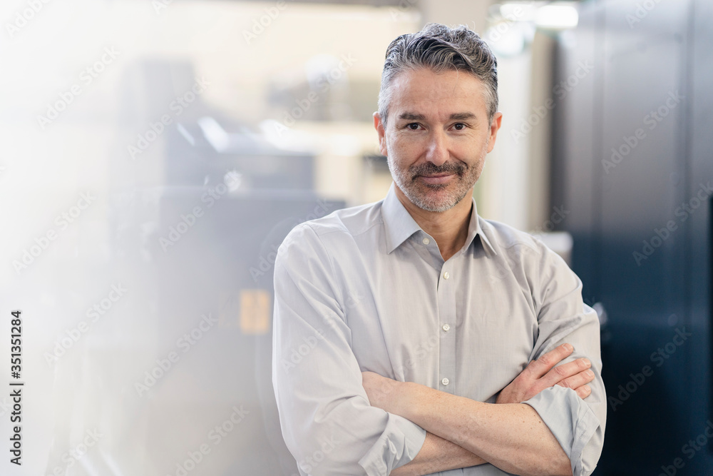 Portrait of a mature businessman standing in company Portrait of a mature businessman standing in company