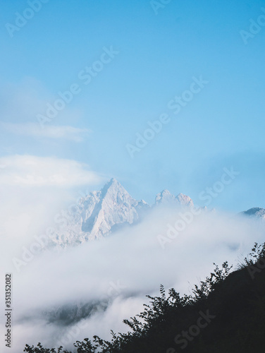 Spain, Cantabria, Clouds shrouding snowcapped peak in Picos de Europa