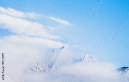 Spain, Cantabria, Clouds shrouding snowcapped peak in Picos de Europa