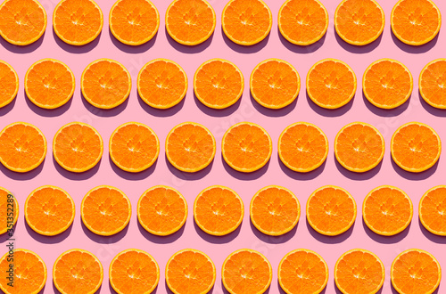 Pattern of orange slices against pink background