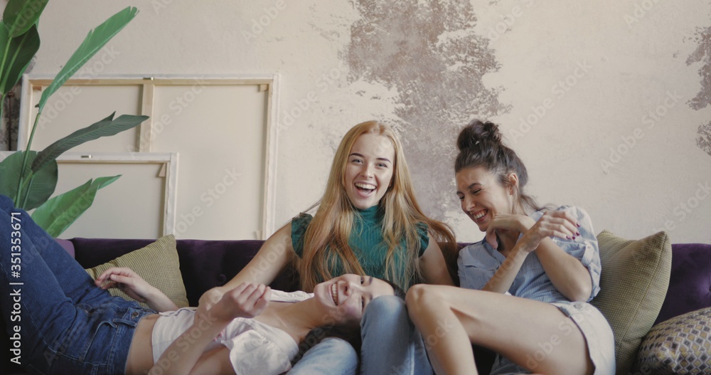 Naklejka premium Young friends on sofa