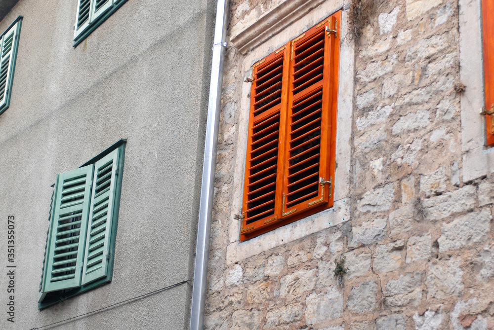 old fashioned window with red and green shutters old fashioned window with red and green shutters