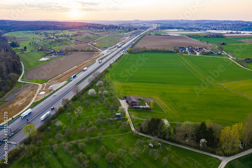 Germany, Baden-Wurttemberg, Kongen, Aerial view of countryside highway at springtime sunset photo