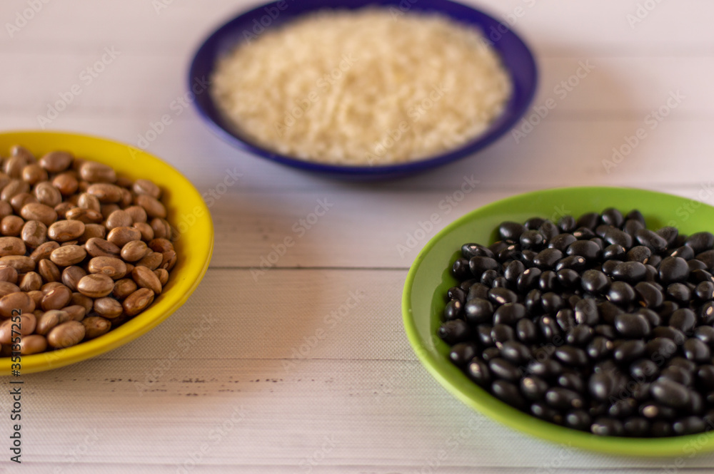 Brazilian Colors in a tradicional brazilian food but raw wihite rice, black and brown beans Brazilian Colors in a tradicional brazilian food but raw wihite rice, black and brown beans