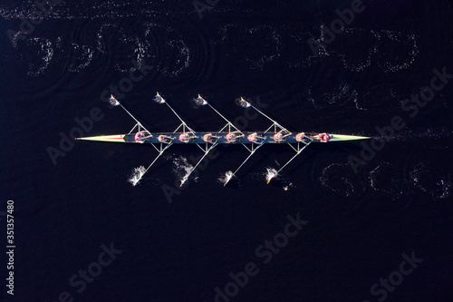 Elevated view of female's rowing eight in water photo