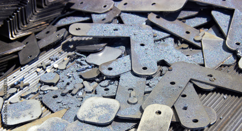 Fototapeta premium metal products on a laser cutting machine with metal filings