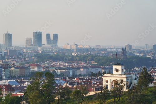 Panoramatic cityscape of Prague, capitol of Czech republic, taken in sunny spring morning after sunset and shown mix of traditional architecture along the Vltava river and modern buildings at horizon.