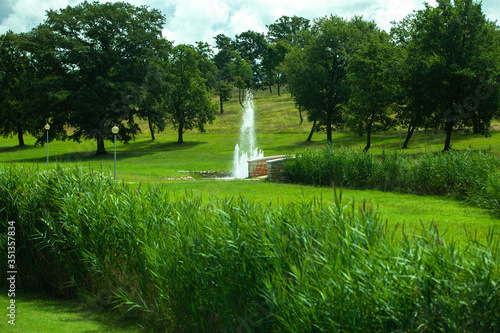Fountain in the park near the stone bridge