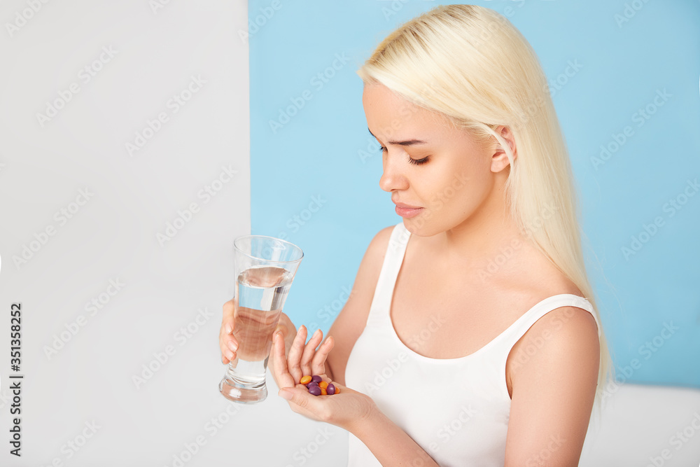 Beautiful woman taking vitamin pill. Dietary supplement Beautiful woman taking vitamin pill. Dietary supplement