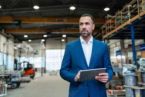 Wallpaper Mural Businessman using tablet in a factory Torontodigital.ca