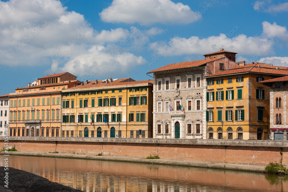 The Arno River that runs alongside the houses of Pisa