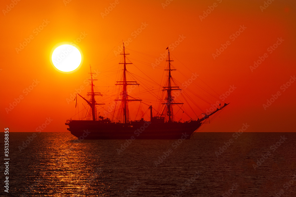 The ship of the Italian Navy Amerigo Vespucci, at sunset, in front of the city of Livorno
